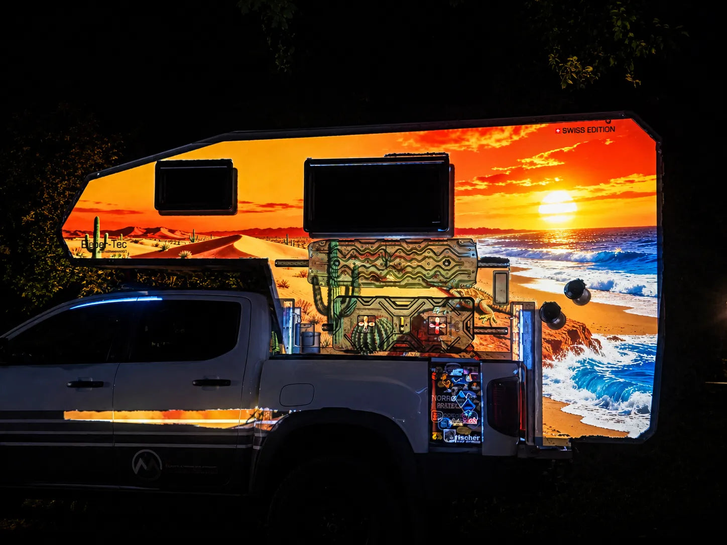 Projection mapped artwork covering the side and camper shell of a pickup truck